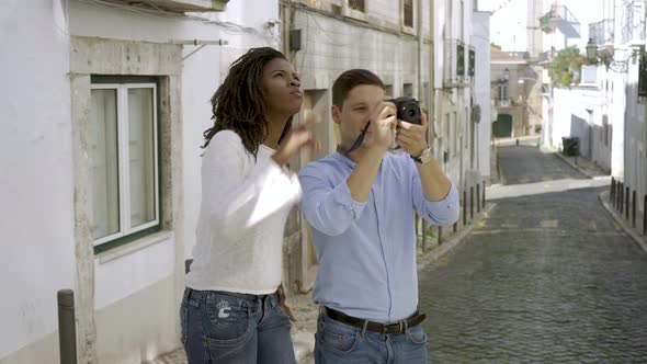 Multiethnic Couple of Tourists Standing in Old City Street