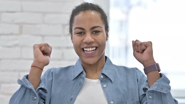 Young African Woman Celebrating Success