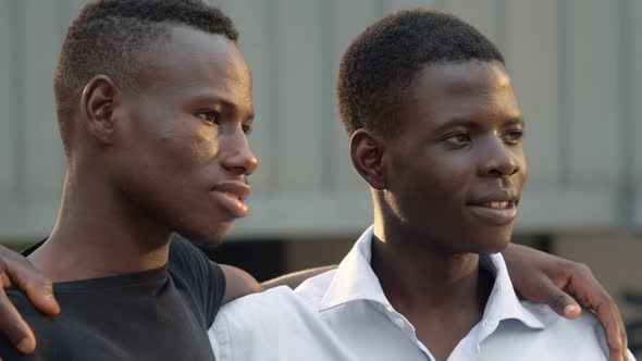 Proud Black african young men in the street looking at each other and smiling