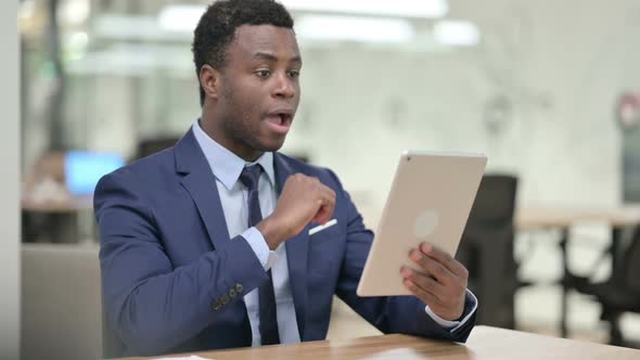 Video Call on Tablet By African Businessman at Work