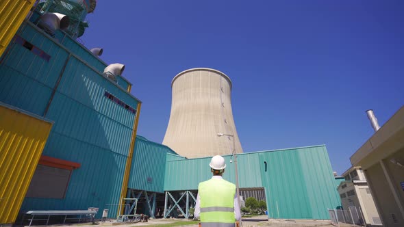 Engineer walking in natural gas electric cycle power plant.