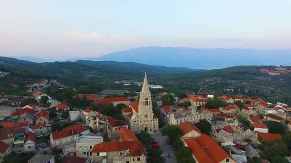 Descending aerial view of St, Nicholas Church in Selca Croatia Europe
