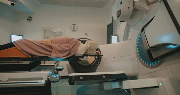 Patient getting Radiation Therapy Treatment inside a large radiotherapy room