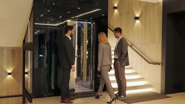 A Group of Business People Enter a Modern Elevator in Business Center