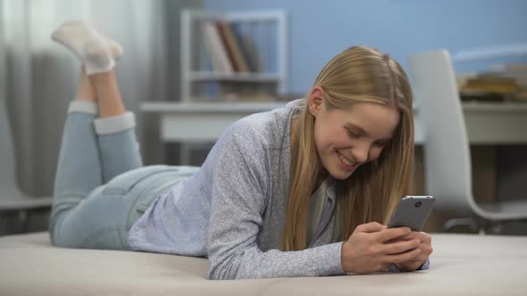 Happy Girl Typing Message to Friend in Social Network First Love in Teen Age