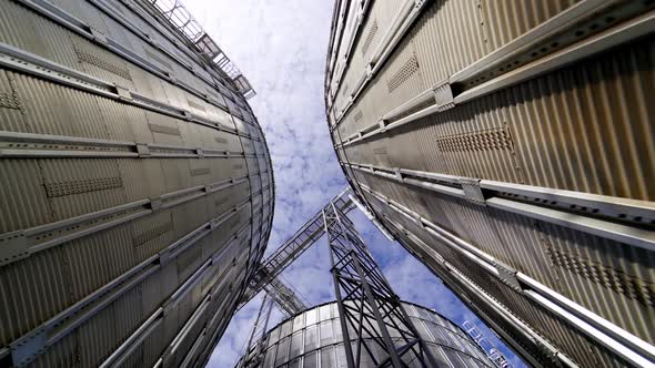 Metal tanks of elevator. Grain-drying complex outdoors. 