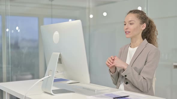 Cheerful Young Businesswoman Doing Video Chat on Desk Top