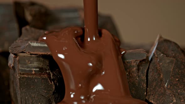 Super Slow Motion Shot of Pouring Melted Chocolate on Raw Chocolate Chunks at 1000 Fps.