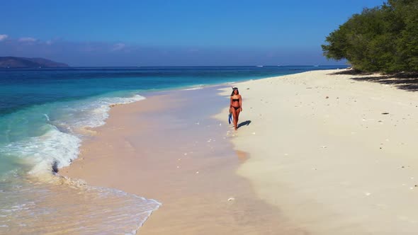 Beautiful women relaxing on tropical coast beach voyage by shallow ocean and white sand background o