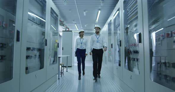 Electrical Workers Walking in the Control Room