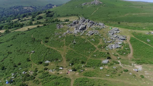 Wide shot aerial tracking forward over Bonehill Rocks, Dartmoor, Devon, England.