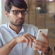 Smiling Indian Business Man Using Cellphone Apps Working in Office - VideoHive Item for Sale