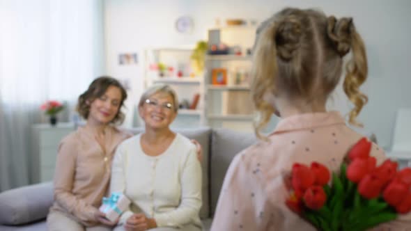 Little Girl Hiding Tulips for Grandmother, Mother Day Celebration, Surprise