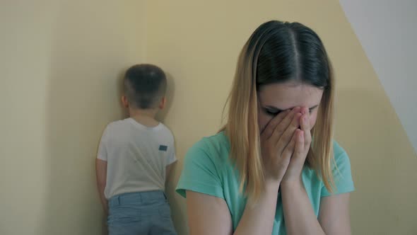 Resentment and Quarrel Between Mom and Little Son Sit Back to Back Closes Ears