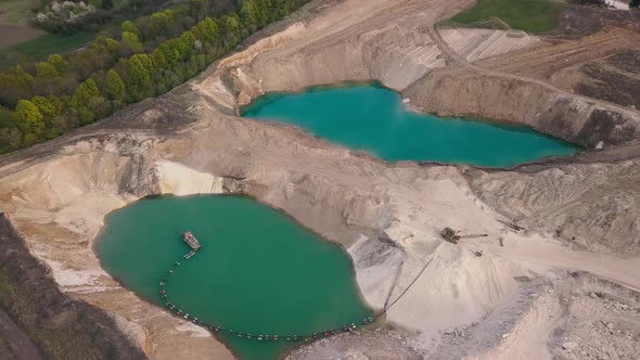 Aerial view of a sand quarry full with green water