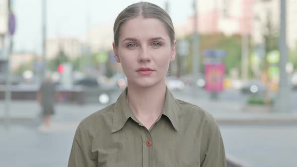 Portrait of Woman Looking at the Camera Outdoor