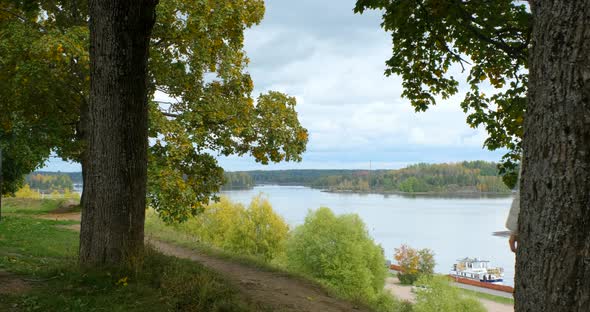 Female Tourist with Travel Bag Is Walking Along Path