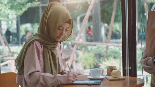 Asian Muslim Women Relaxing in the Coffeeshop 02