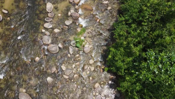 Aerial top down view water flow over the rock