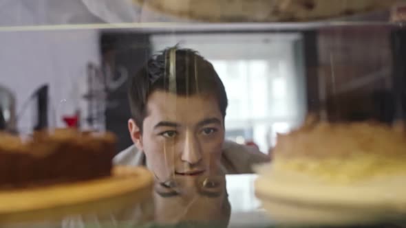 Young Man Tempted by Sweet Food