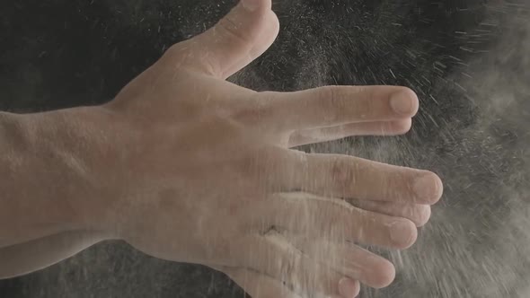 Closeup of Male Hands Shaking Off Flour