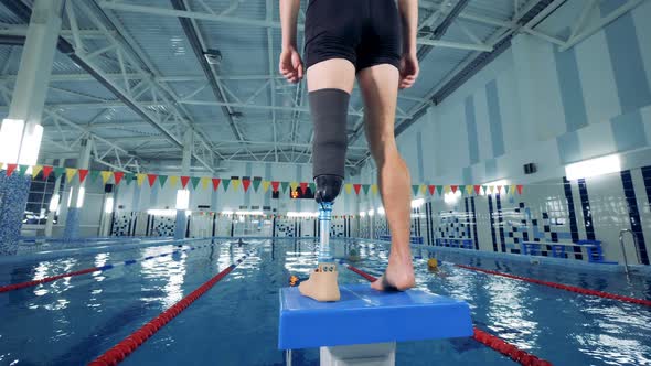 Handicapped Man Warming Up Before Swimming, Back View.