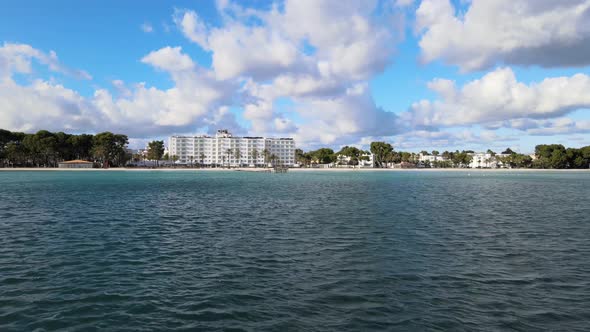 Flying Above Water in the Sea Over Building and Land