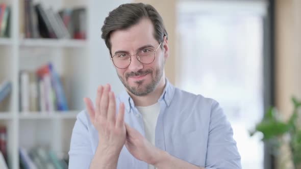 Portrait of Man in Glasses Clapping Applauding