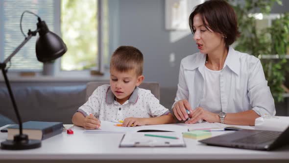 Mother Helping Son with Homework