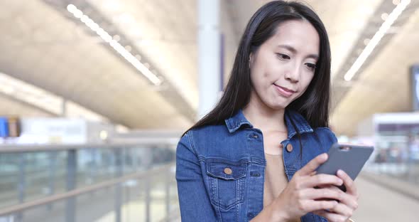 Woman use of mobile phone in Hong Kong airport 