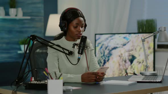 African Blogger Woman Reading Messages on Smartphone