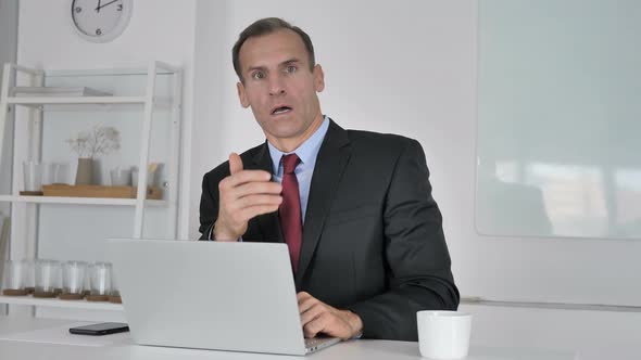 Shocked Middle Aged Businessman Wondering While Looking at Camera