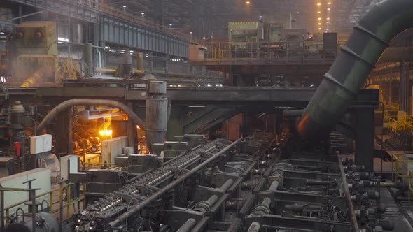 Steel Mill, Steel Pipes Production, Red-hot Pipe Transported on Production Line, Heavy Industry