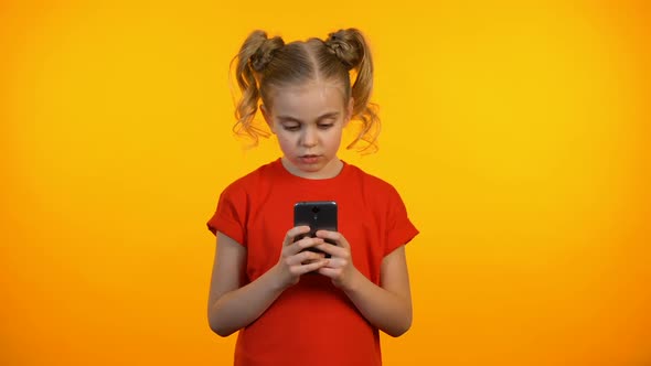 Thoughtful Preteen Girl Typing on Smartphone, Communicating With Friends Online