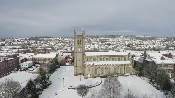 Aerial view of St Jame's church covered in snow in the midlands, Christian, Roman catholic religious