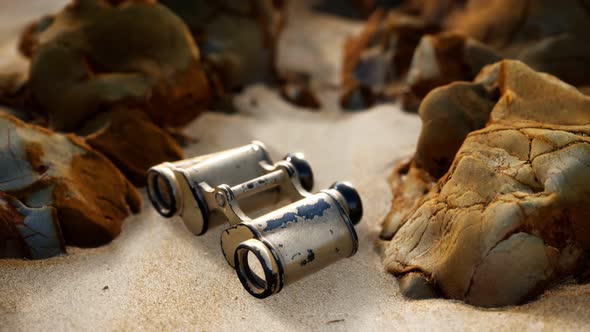 Old German Military Binoculars on the Sand Beach