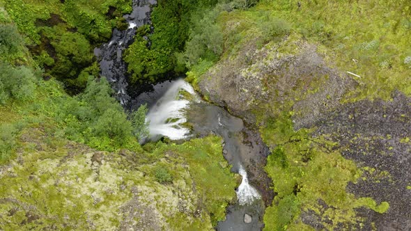 Flying Above Nauthúsagil Waterfall With Lush Vegetations On Rugged Cliffs In Iceland. Aerial Shot