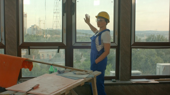 Young Worker on Construction Site Looking at City