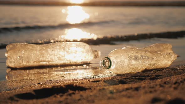 Debris in the Sea  Plastic Bottles at the Edge of the Water on the Beach