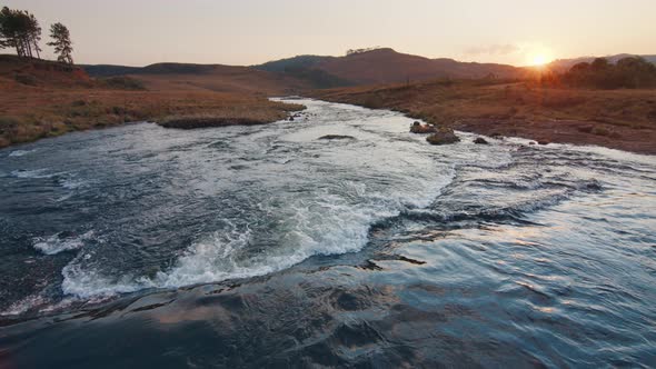 Rapid River Flows in Brazilian Mountains at Sunset