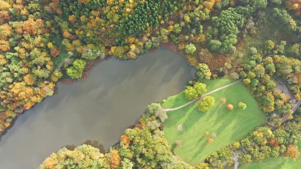 Aerial Above Lake with Autumn Foliage and Tree Reflections in Styria Thal Austria