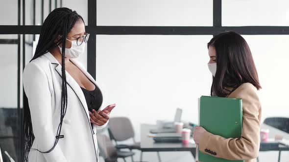 Business Colleagues Talking While Standing in Modern Office