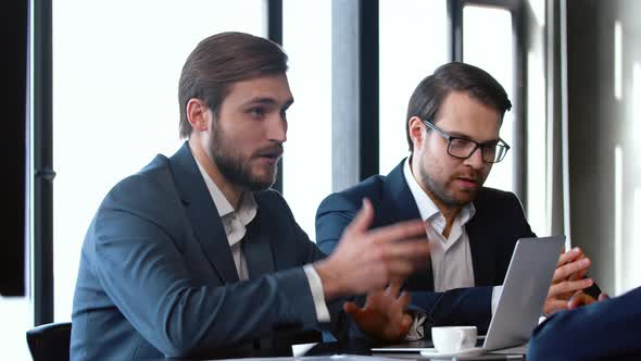 Company managers brainstorm plan working together with laptop