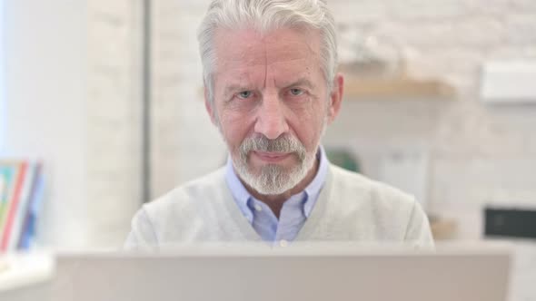 Close Up of Thumbs Up By Old Man at Work