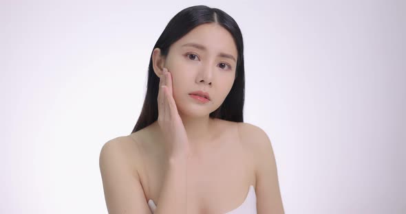 Young Asian Woman Touching Her Face Softly. Feeling Worry About Face Skin Care Problem On Cheek.