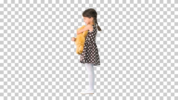 Little girl in polka dot dress hugging, Alpha Channel