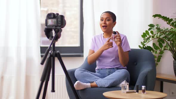 Female Beauty Blogger with Camera and Perfume