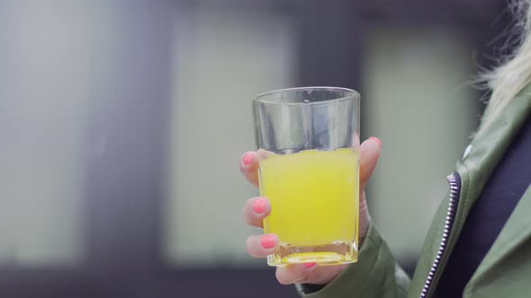 Young European Girl Holding a Glass of Soda