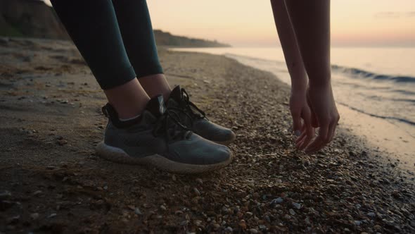 Unknown Girl Hands Reaching to Ground on Beach Close Up