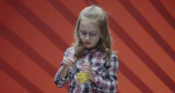 Girl Eating Pineapple From Plastic Cup